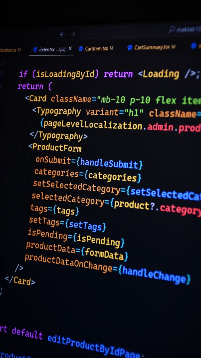collection-03 Close-up of JSX code on a monitor, showcasing colorful syntax used in ReactJS development.